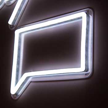 White neon sign of chat bubble